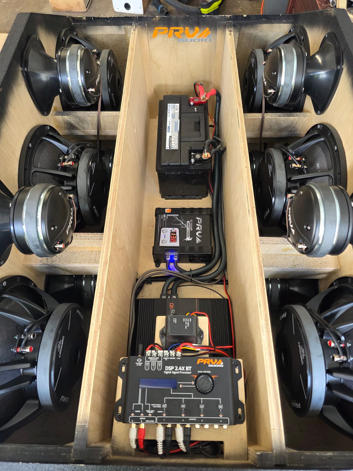 Interior of Stuntwalls Stuntbox GameDay MAX portable pro audio sound system showing PRV Audio speakers, compression drivers, DSP, battery and power supply / charger. 